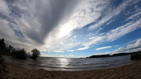 Time lapse. Clouds and sun over the water. Stock Footage 100665448
