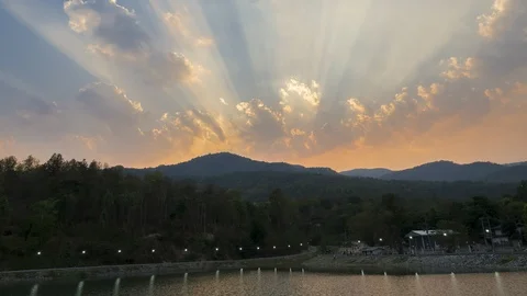Time lapse of Clouds and sunbeam mountain and reservoir in evening. Stock Footage 107427335