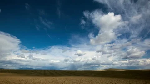 Time Lapse of Clouds and Tractor Harrowing Field Stock Footage 22240859