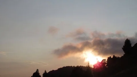 Time Lapse - Clouds and Trees front of Sunset Stock Footage 100901445