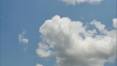 Time lapse clouds are floating from the bottom to the top on sunny blue sky Stock Footage 132681420