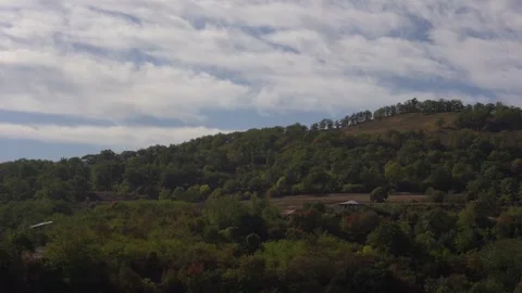 Time lapse clouds are moving over the green mountain forest Stock Footage 255007764