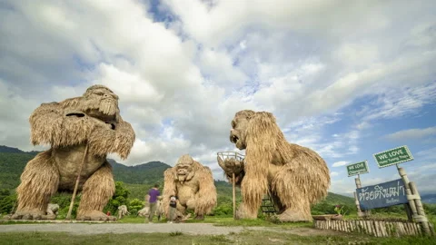 Time lapse of clouds behind man made straw gorillas statues in Huay Tung Tao Stock Footage 198786264