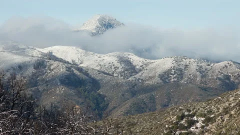 Time lapse of clouds below a snowy Strawberry Peak in the San Gabriel Mountains 스톡 동영상 137195563