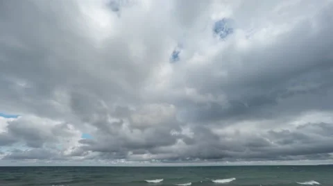 Time Lapse Clouds on Blue Sky  with Waves on Water Stock Footage 55791669