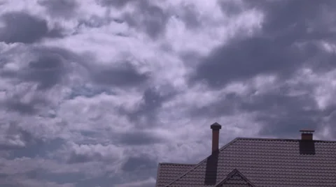 Time-lapse clouds in blue sky over roof of the brown house Stock Footage 62973084