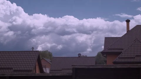 Time-lapse clouds in blue sky over roof of the brown house Stock Footage 62973519
