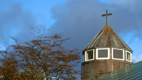 Time lapse of clouds in a blue sky moving behind a church in background Stock Footage 92640914