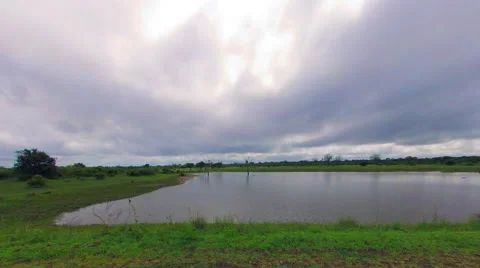 Time-lapse: Clouds casts shadows over a waterhole Stock Footage 48831421