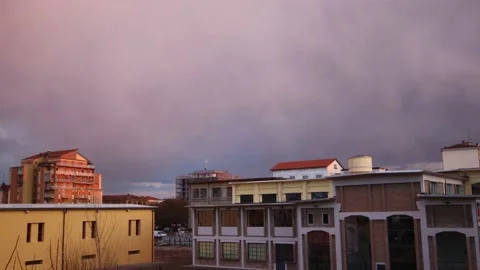 Time lapse Clouds change color over the buildings 2 4K - Italian nature Video stock 151197230