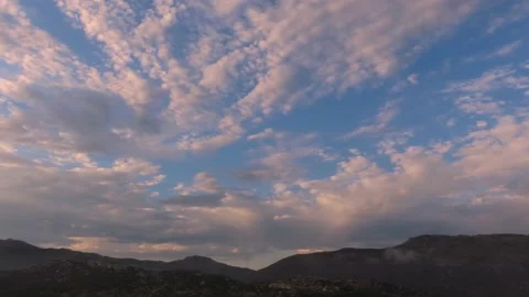 Time lapse of the clouds changing color at sunset Stock Footage 154410659