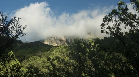Time lapse of clouds clearing over a mountain peak Stock Footage 67383383