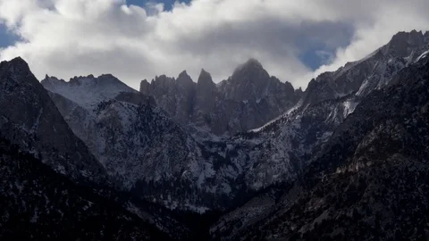 Time lapse of clouds clearing from the top of a snowy Mount Whitney in winter Video stock 74753953