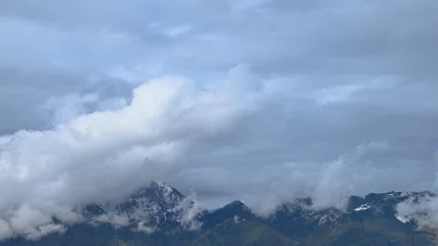 Time lapse clouds covering Alps mountains Stock Footage 140181630