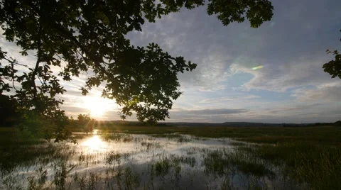 Time lapse of clouds covering estuary Stock Footage 66776945