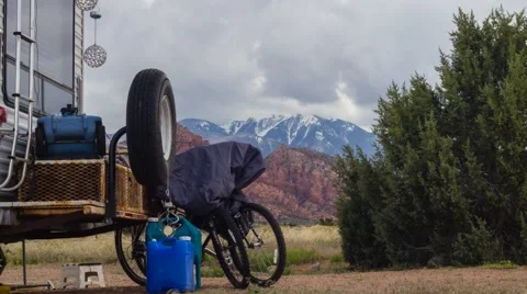 Time Lapse of Clouds covering a Mountain with Trailer in foreground Stock Footage 63171043