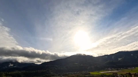 Time lapse of clouds covering the sun with hills Stock Footage 318449545