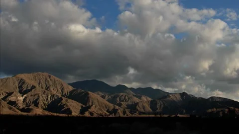 Time lapse clouds cross a southern california mountain range Stock Footage 246172145