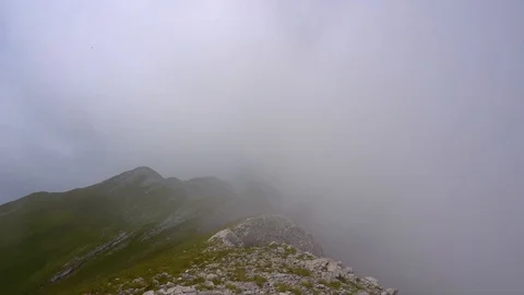 Time lapse of clouds disappearing during a hike in the mountains Stock Footage 118085766
