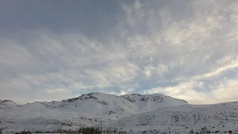 Time lapse clouds dispersing after snowfall over snow-covered Ural mountains Stock Footage 339559177