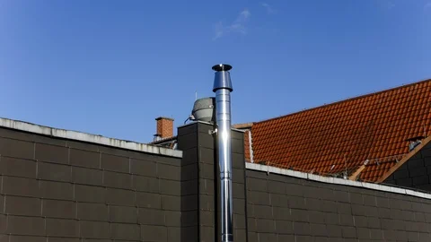 Time-Lapse of Clouds Drifting behind Metallic House Chimney Stock Footage 121225215