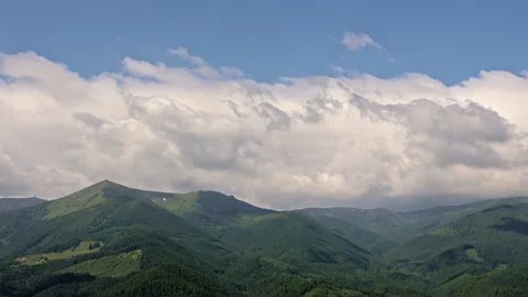Time lapse of clouds drifting over green mountain range. Time lapse footage of Video stock 313141935