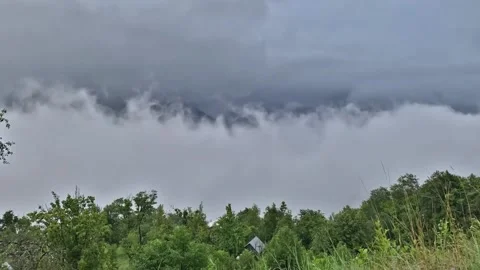 Time lapse clouds float in the mountains Stock Footage 151009684