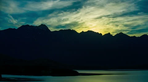 Time Lapse - Clouds float over Lake at Sunrise Stock Footage 60497489