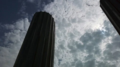 Time lapse of clouds floating around a modern skyscrapers Stock Footage 107402392