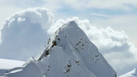 Time-lapse of clouds floating over snowy mountains Stock Footage 113261663