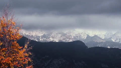 Time lapse of clouds floating over snow capped mountains Stock Footage 119545445