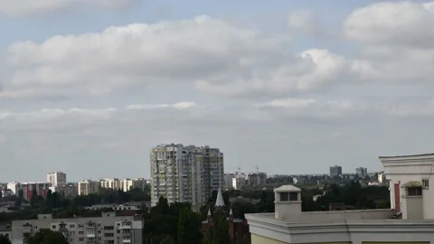 Time lapse clouds floating over city skyline Stock Footage 145352942
