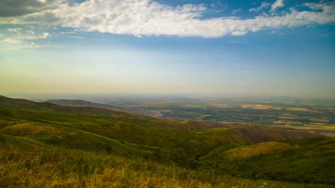 Time lapse of clouds flowing above flat land suburbs at east of Bishkek in 動画素材 335688128