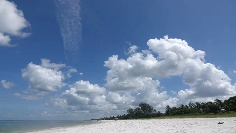 Time Lapse of Clouds Flowing Over Beach Stock Footage 77171612