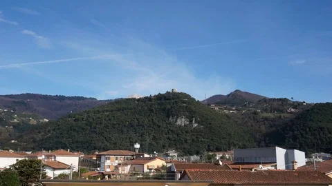 Time lapse of the clouds flowing over a hill with a castle Stock Footage 124013814