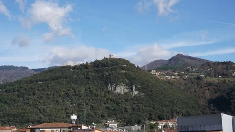 Time lapse of the clouds flowing over a hill with a castle Stock Footage 124013838