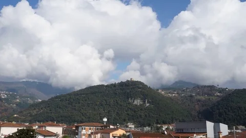 Time lapse of the clouds flowing over a hill with a castle Stock Footage 124013857