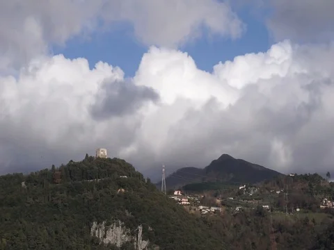 Time lapse of the clouds flowing over a hill with a castle Stock Footage 124013891