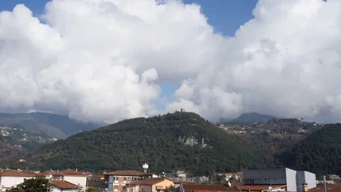 Time lapse of the clouds flowing over a hill with a castle Stock Footage 124013901