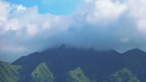 Time lapse of clouds flowing over Hawaiian mountains in 4k Stock Footage 151931703