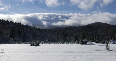 Time-lapse of clouds flowing over the mountain peak on a winter sunny day Stock Footage 170013674