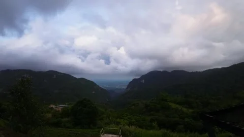 Time-lapse of clouds flowing through the valley at dusk Stock Footage 313339894