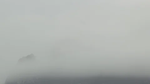 Time lapse clouds fly against a snowy mountain peak Stock Footage 104549140