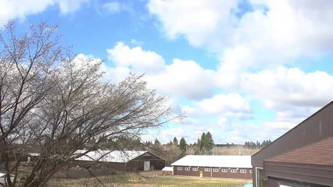 Time Lapse of clouds flying over a farm Stock Footage 146619025