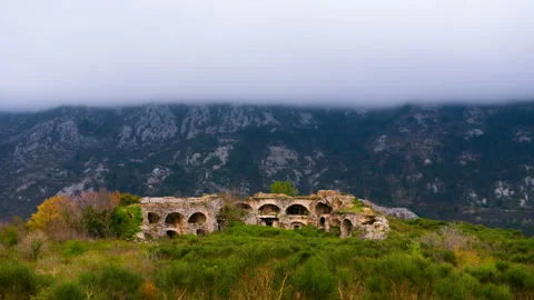 Time lapse. Clouds forming against the mountain, foreground old fortress Stock Footage 108826926