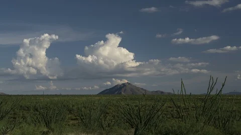 Time lapse of clouds forming over an isolated mountain in the desert Stock Footage 113914384
