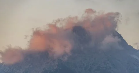 Time lapse clouds forming over alpine mountain summit Stock Footage 134394418