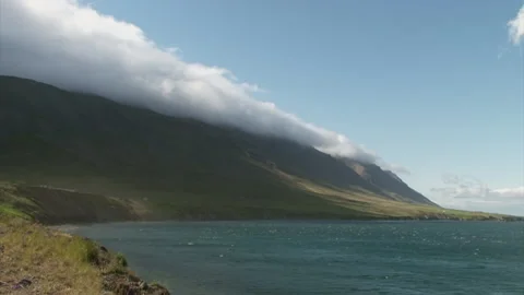 Time lapse of clouds gathering around a mountain ridge in Iceland close to Stock Footage 160101560