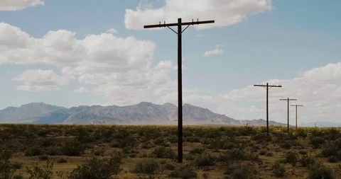 Time Lapse Clouds Gentle Movement Over Power Lines in Desert Landscape Stock Footage 108628806