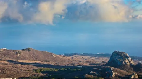 Time Lapse Clouds - HD. Sunset over the sea and mountains. Stock Footage 22085926